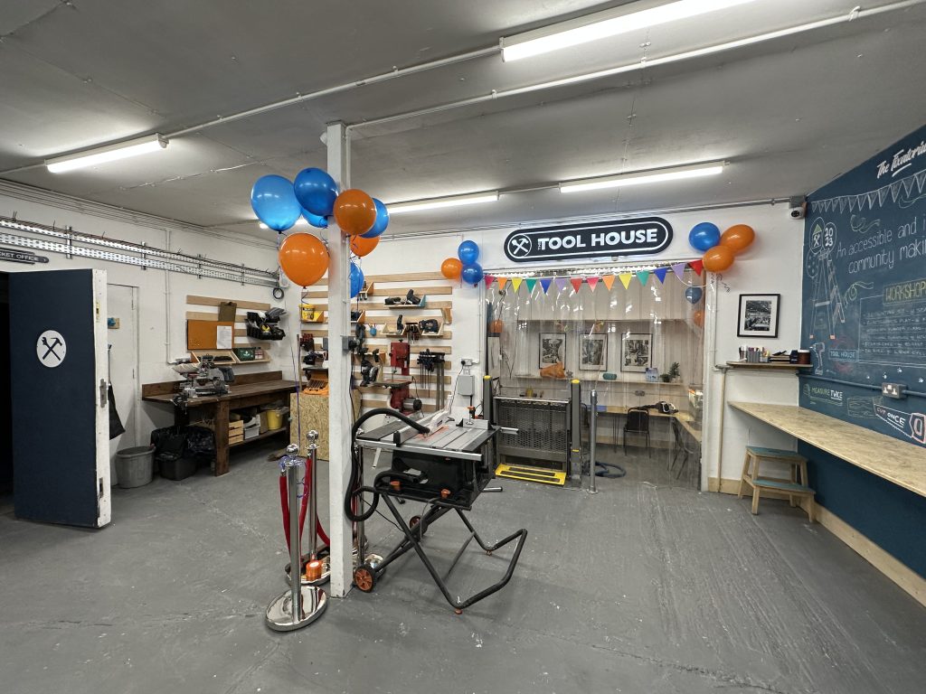 People working together at the shared bench in The Tool House workshop